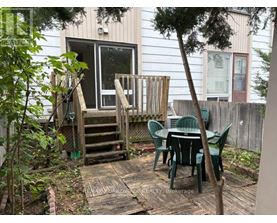 A backyard with a table and chairs.