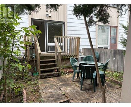 A backyard with a table and chairs.