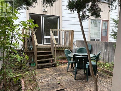 A backyard with a table and chairs.