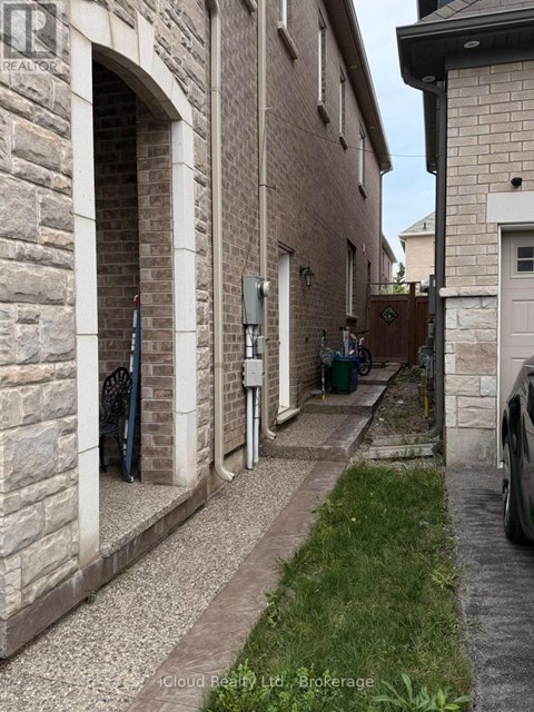 A narrow alley between two buildings with a car parked on the right side.