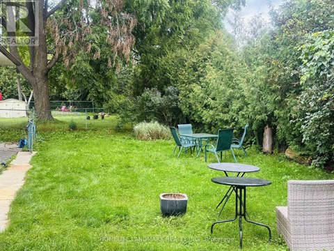 A backyard with a table and chairs.