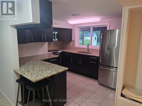 A kitchen with granite countertops and stainless steel appliances.