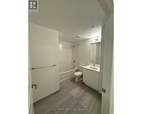 A white bathroom with a toilet, sink, and bathtub.