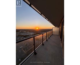 A sunset view from a balcony of a building.