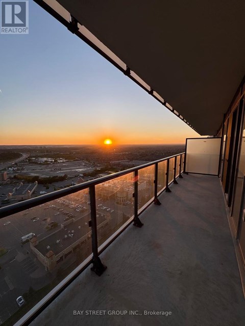 A sunset view from a balcony of a building.