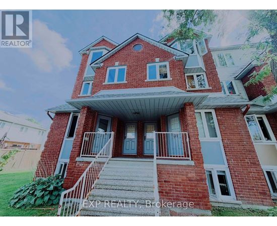 A red brick house with a white porch and a sign that says EXP REALTY Brokerage.