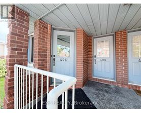 A house entrance with a white railing and a grey door.