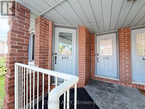 A house entrance with a white railing and a grey door.