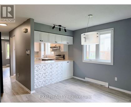 A kitchen with a white counter and cabinets.