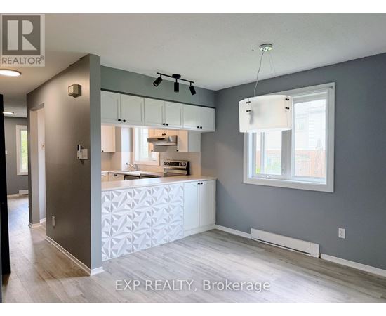 A kitchen with a white counter and cabinets.