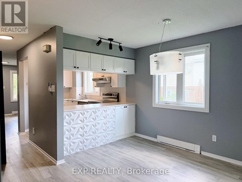 A kitchen with a white counter and cabinets.