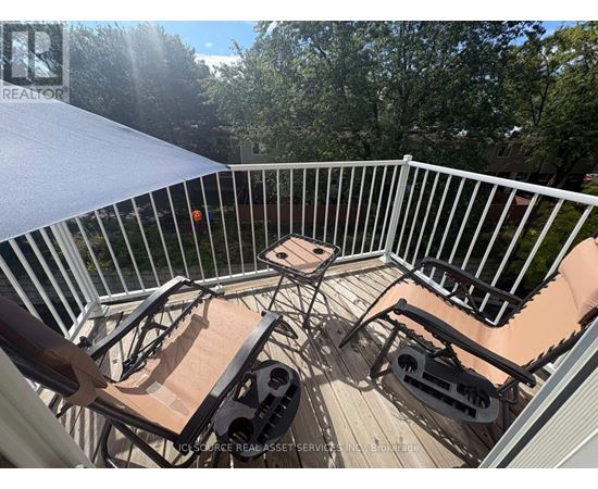 A patio with a table and chairs is set up on a deck.