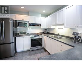A kitchen with white cabinets and stainless steel appliances.