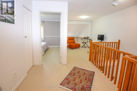 A living room with a couch and a rug on the floor.
