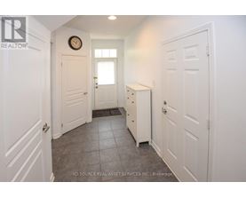 A hallway with white doors and a clock on the wall.