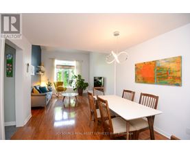 A dining room with a table and chairs.