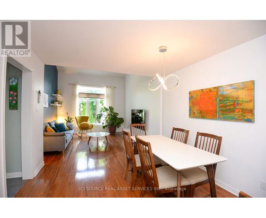 A dining room with a table and chairs.