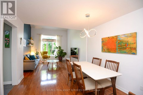A dining room with a table and chairs.