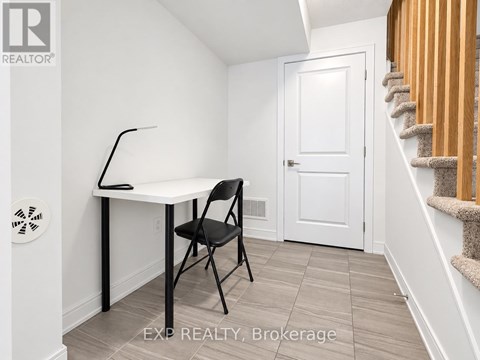 A room with a desk and chair in it.