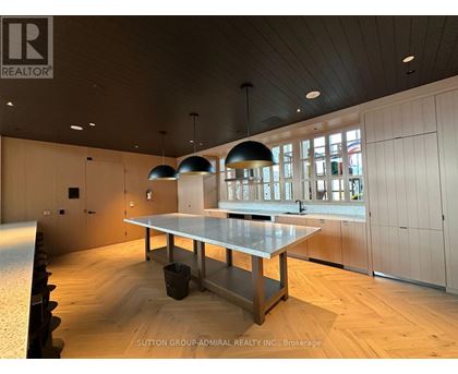 A conference room with a long table and chairs.