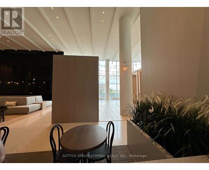 A modern living room with a dining table and chairs.