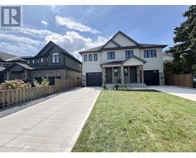 A large, modern house with a well-maintained lawn and a clear sky above.