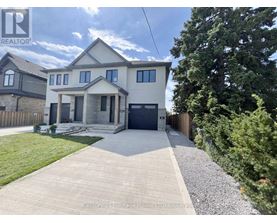 A house with a grey front yard and a gravel pathway leading to the front door.