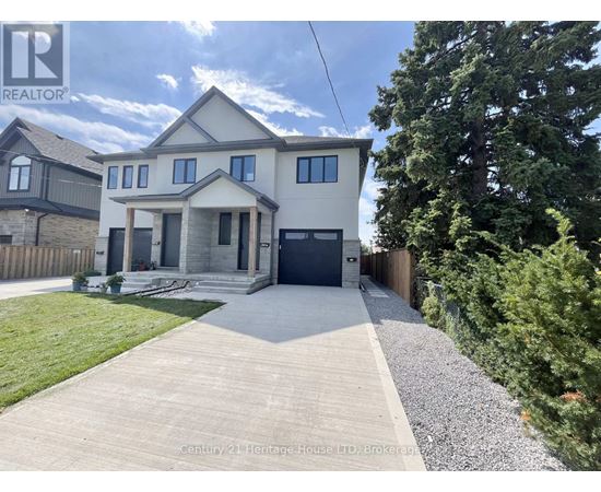 A house with a grey front yard and a gravel pathway leading to the front door.