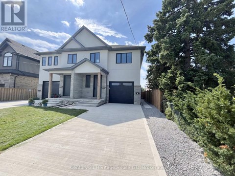 A house with a grey front yard and a gravel pathway leading to the front door.