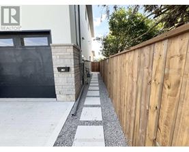 A wooden fence runs along the side of a house.