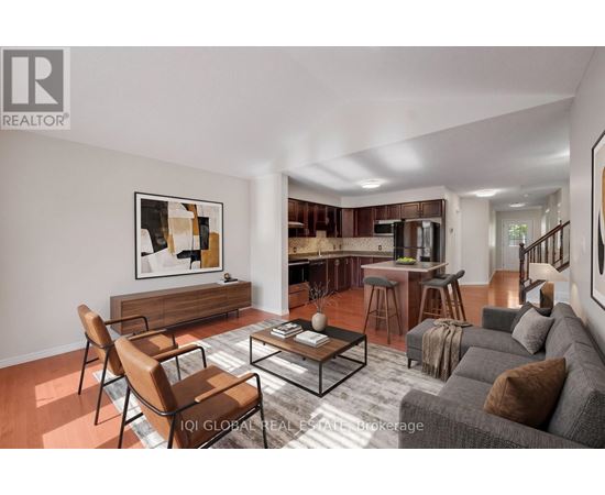 A living room with a grey couch, a coffee table, and a painting on the wall.