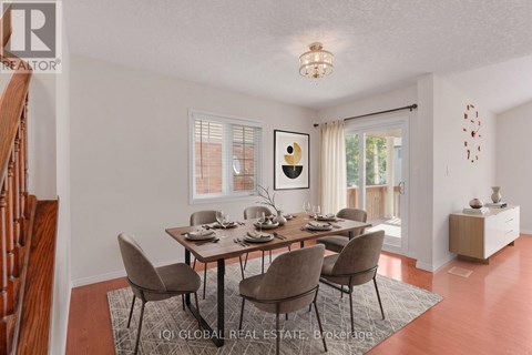 A dining room with a table set for six.