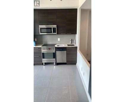 A modern kitchen with a stainless steel oven and microwave.