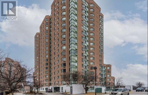 A tall building with a glass facade is the main focus of the image.