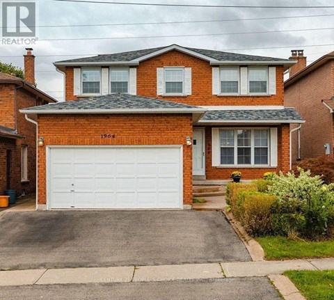 A red brick house with a white garage door.