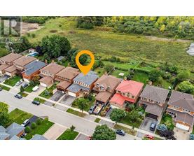 A bird's eye view of a residential area with houses and streets.