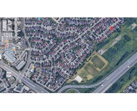 A satellite image of a residential area with houses, roads, and a few marked locations.