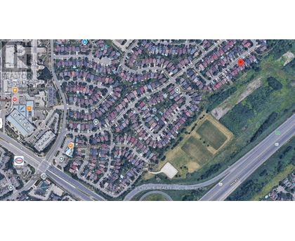 A satellite image of a residential area with houses, roads, and a few marked locations.