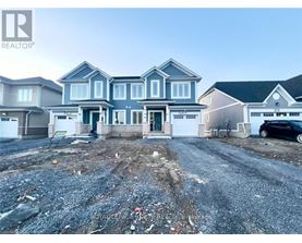 A realtor photo of a house with a gravel driveway in front.