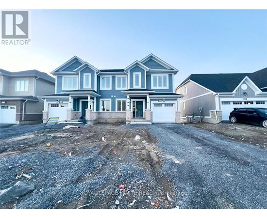 A realtor photo of a house with a gravel driveway in front.