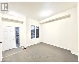 A white door is on the left and a window with a view of a building is on the right.