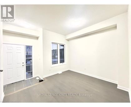 A white door is on the left and a window with a view of a building is on the right.