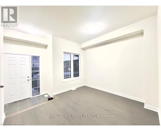 A white door is on the left and a window with a view of a building is on the right.