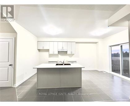 A spacious kitchen with white cabinets and a large island.