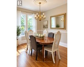 A dining room with a round table and chairs.