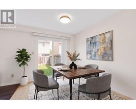 A dining room with a table and chairs.