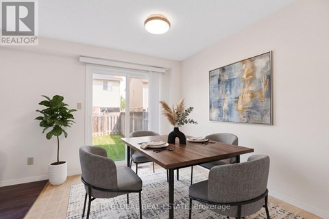 A dining room with a table and chairs.