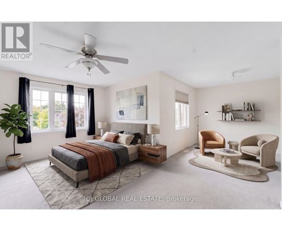 A bedroom with a bed, a chair, and a potted plant.