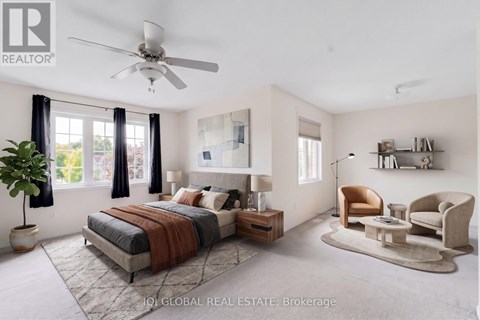A bedroom with a bed, a chair, and a potted plant.