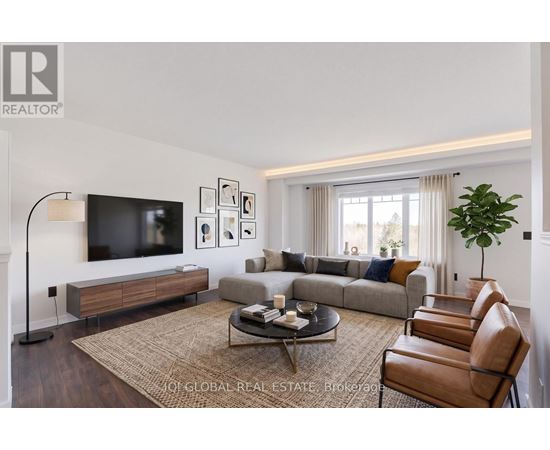 A living room with a couch, chairs, and a television.